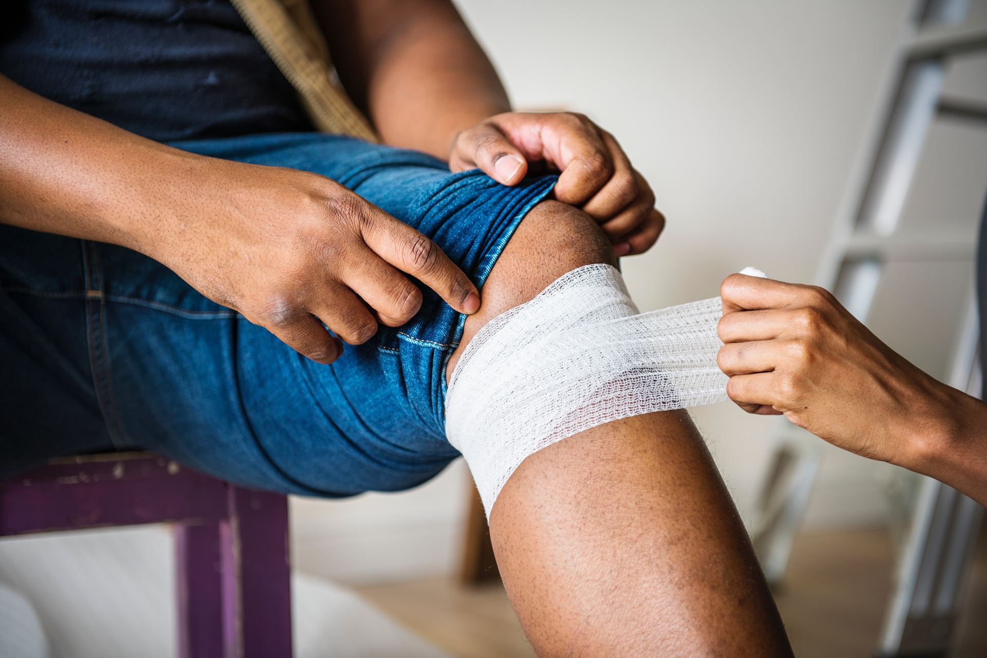 Person getting knee bandaged